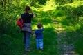 Young mother walking with her little son outdoors in summer Royalty Free Stock Photo
