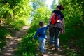 Young mother walking with her little son outdoors in summer Royalty Free Stock Photo