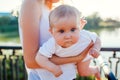 Young mother walking in summer park with her baby girl. Happy woman holding kid outdoors Royalty Free Stock Photo