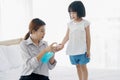 Asian Young mother washes her little girl`s hand by using a hand wash sanitizer gel. In the epidemic virus situation