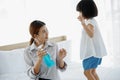 Asian Young mother washes her little girl`s hand by using a hand wash sanitizer gel. In the epidemic virus situation