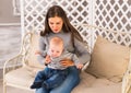 Young mother woman holding and hugging in her arms child baby kid boy smilling laughing Royalty Free Stock Photo