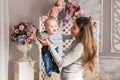 Young mother woman holding and hugging in her arms child baby kid boy smilling laughing Royalty Free Stock Photo