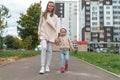 Young mother woman, walks autumn with little boy, son 3-5 years old, happy smiling weekend walk from kindergarten, high Royalty Free Stock Photo