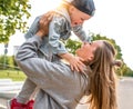 Young mother woman happy plays with little boy 3-5 years old, in city park, autumn clothes on nature, fun joy and