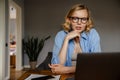 Young mother working with laptop while spending time with her baby Royalty Free Stock Photo