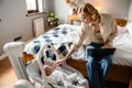 Young mother working with laptop while spending time with her baby Royalty Free Stock Photo