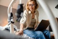 Young mother working with laptop while spending time with her baby Royalty Free Stock Photo