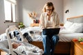 Young mother working with laptop while spending time with her baby Royalty Free Stock Photo