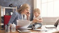 Young mother working and spending time with baby