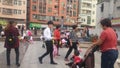 Shenzhen, China: Young mothers or grandmothers play outdoors with their children