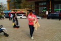 Shenzhen, China: Young mothers or grandmothers play outdoors with their children