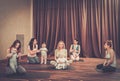 Young mothers and their babies doing yoga exercises on rugs at fitness studio. Royalty Free Stock Photo