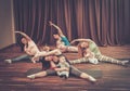 Young mothers and their babies doing yoga exercises on rugs at fitness studio. Royalty Free Stock Photo