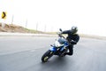 Young motorcyclist on a Susuki bike driving on a road