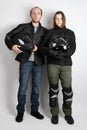 Young motorcyclists man and woman in studio