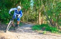 A young mountain biker riding through bush land