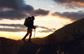 Young mountaineer standing with backpack on top of a mountain Royalty Free Stock Photo