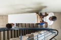 Young Movers Carrying Shelf While Climbing Steps