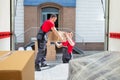 Young Movers Unloading The Boxes In The Van Royalty Free Stock Photo