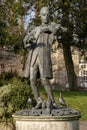 Young Mozart statue at a park with cloudy sky