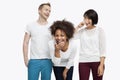 Young multi-ethnic friends in casuals laughing over white background