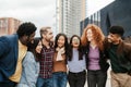Young multi ethnic friends having fun together hanging out in the city Royalty Free Stock Photo