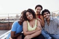 A young multi-ethnic group of smiling friends hugging each other. Portrait photo of young cheerful mixed race people looking at Royalty Free Stock Photo