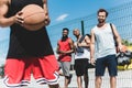 Young multicultural men playing basketball on court Royalty Free Stock Photo