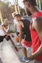 Young multicultural men playing basketball on court Royalty Free Stock Photo