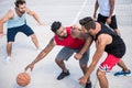 Young multicultural men playing basketball on court Royalty Free Stock Photo