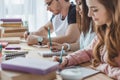 young multicultural students writing