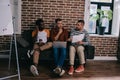 young multicutural businessmen sitting on sofa