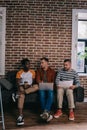 young multicutural businessmen sitting on sofa