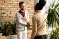 Young multiethnic business couple handshaking in the modern office Royalty Free Stock Photo