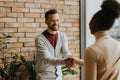 Young multiethnic business couple handshaking in the modern office Royalty Free Stock Photo