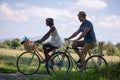 Young multiethnic couple having a bike ride in nature Royalty Free Stock Photo