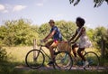 Young multiethnic couple having a bike ride in nature Royalty Free Stock Photo