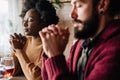 Young multiethnic couple praying to Lord to bless their food and day Royalty Free Stock Photo