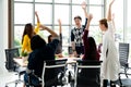 Young multiethnic diverse creative asian group huddle and high five hands together in office workshop with success or empower Royalty Free Stock Photo