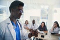 Young multiethnic interns listening lecture afro american doctor at medical conference in the clinic. During lecture the