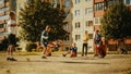 Young Multiethnic Kids Playing with Ball in the Neighborhood. Young Boy Practicing Soccer Drills