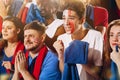 French emotive football, soccer fans cheering their team with blue scarfs at stadium. Concept of sport, emotions, team Royalty Free Stock Photo
