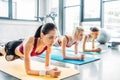 young multiethnic sportswomen doing plank on fitness mats