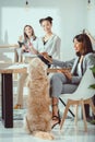 young multiethnic women in formal wear working with dog Royalty Free Stock Photo