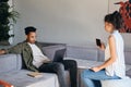 Young multinational casual couple working together in co-working space