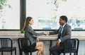 Young multiracial business people hands shake for making agreement at coffee shop Royalty Free Stock Photo
