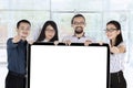 Young business team holding placard Royalty Free Stock Photo