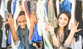 Young multiracial couple having fun at clothing flea market - Be