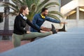 Young multiracial couple stretching leg before running, training outdoors. Copy space. Royalty Free Stock Photo